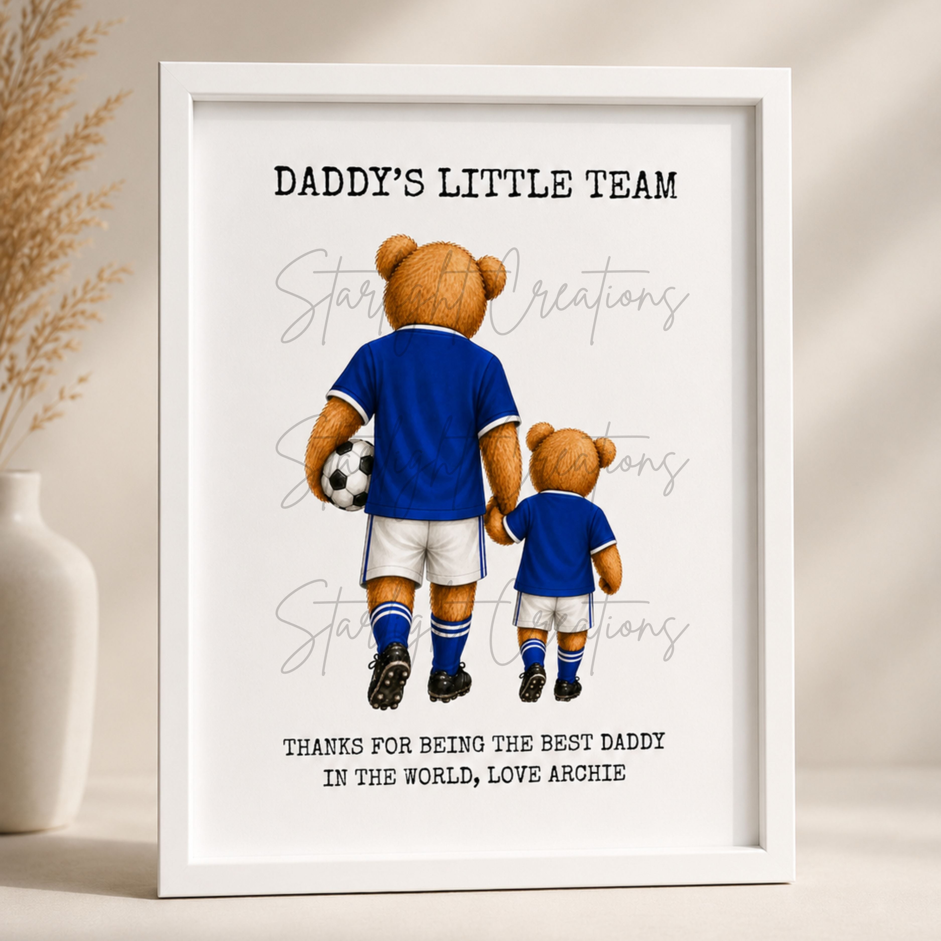 Framed artwork with two teddy bears in blue sports jerseys holding hands, with text 'Daddy's Little Team' and 'Thanks for being the best daddy in the world, Love Archie'.