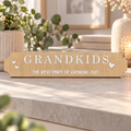 Wooden Grandkids street sign with white lettering and hearts, reading “The best part of growing old