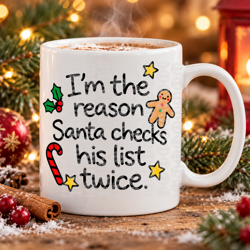 White ceramic funny Christmas mug with the slogan “I’m the reason Santa checks his list twice”, gingerbread man, candy cane and holly, filled with hot chocolate