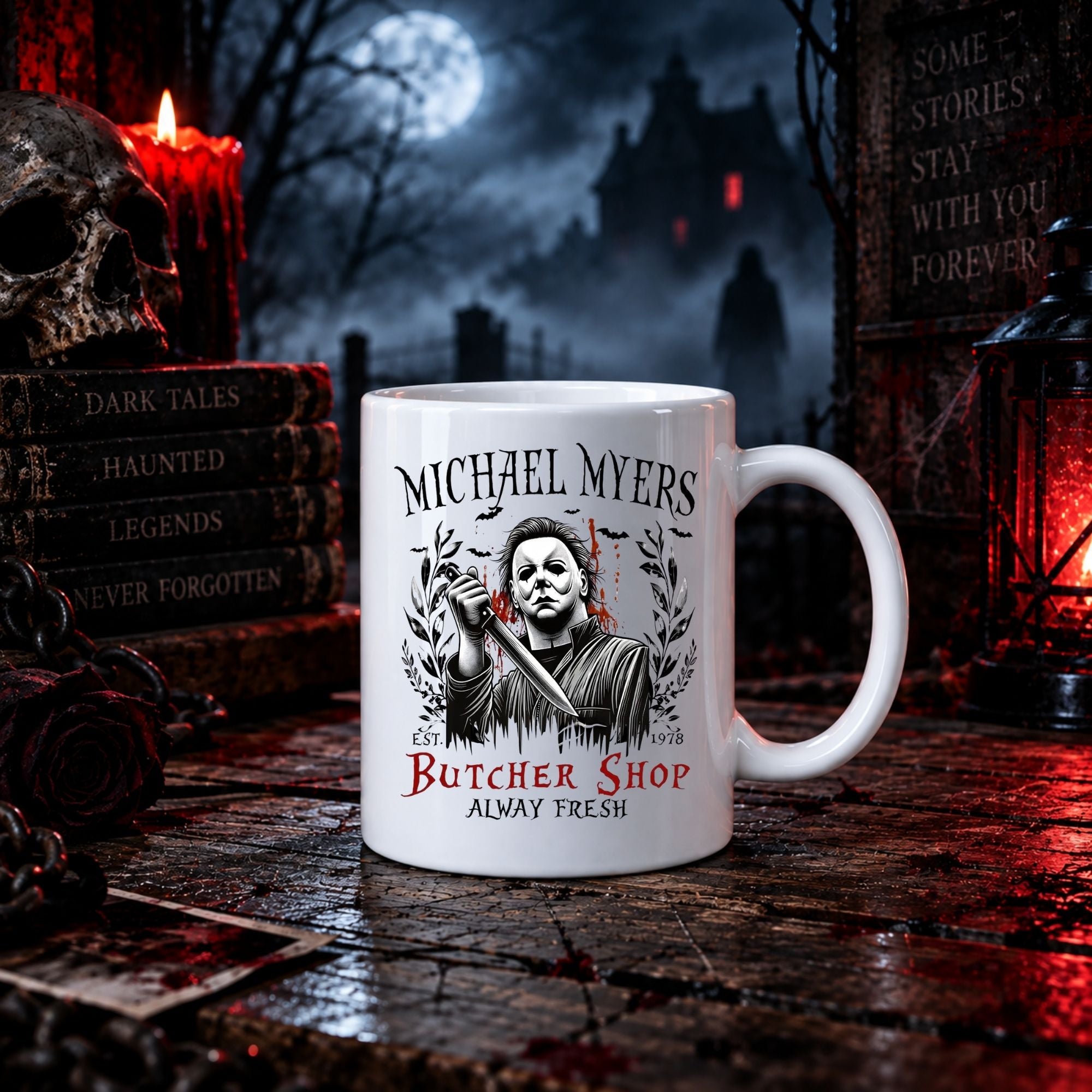 A white ceramic mug with a black and red graphic of Michael Myers from Halloween, set on a dark, spooky tabletop with candles, a skull, and haunted house decorations in the background.