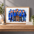 A framed custom cartoon illustration of five men wearing blue football jerseys and scarves, displayed on a wooden shelf in a styled room setting with plants and a candle.