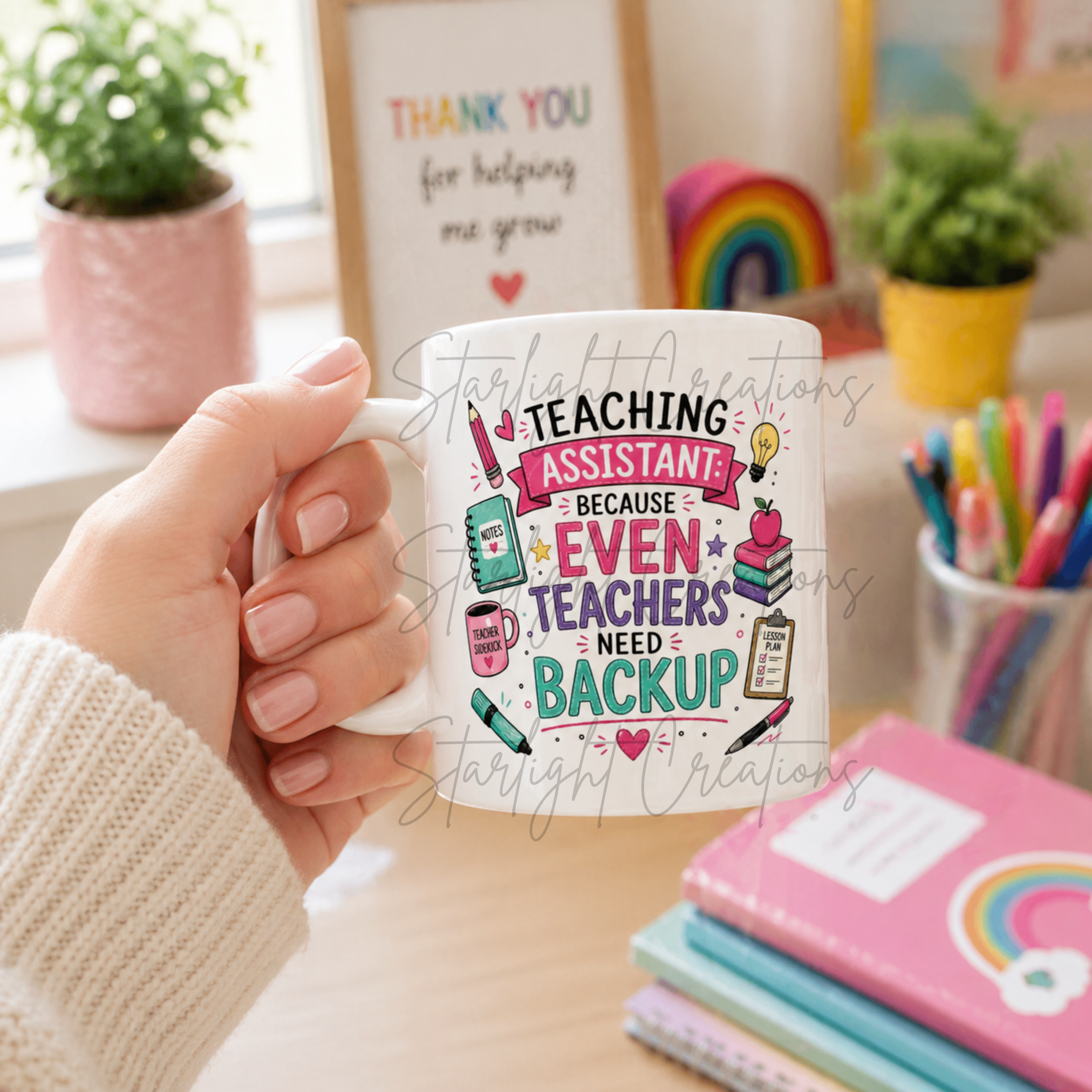Person holding a mug with 'Teaching Assistant' design in a classroom setting