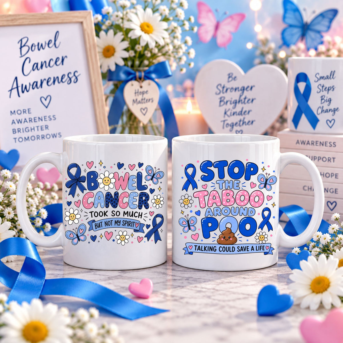 Two white ceramic mugs with colorful Bow Cancer Awareness-themed printed designs, displayed in a styled awareness setting with flowers, blue ribbons, candles, and supportive signs.