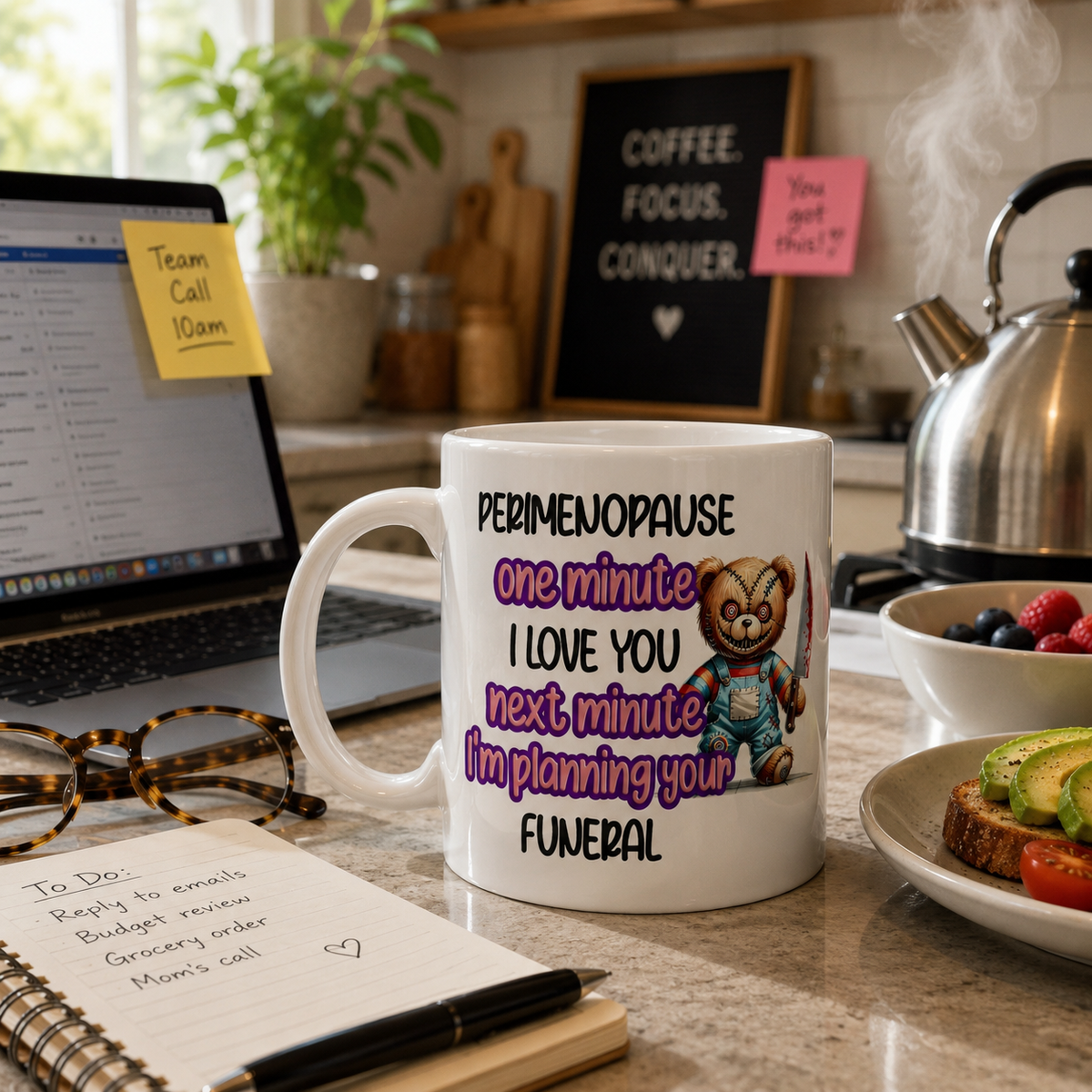 Mug with humorous text and bear graphic on a kitchen counter with laptop and food.
