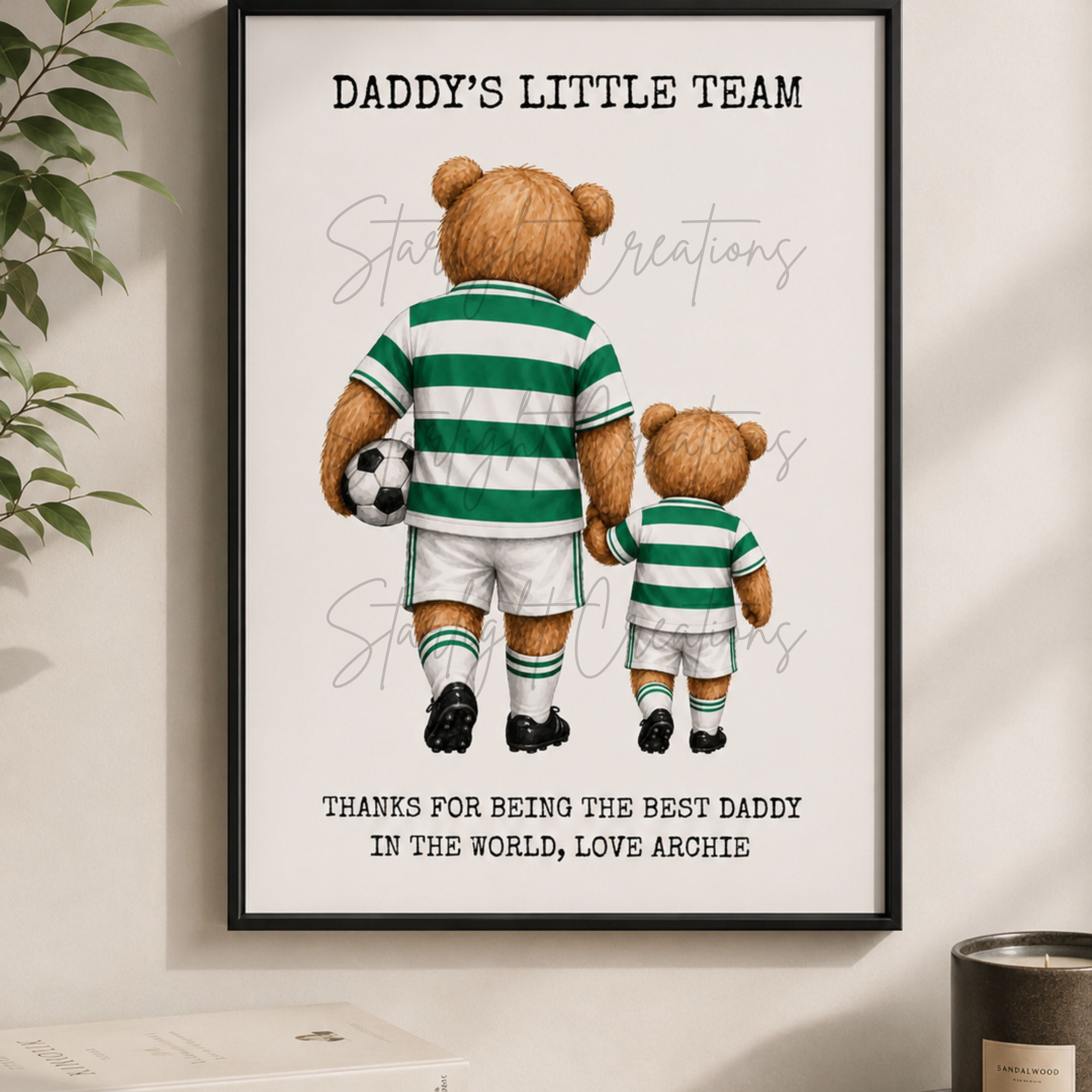 Framed artwork with two teddy bears in green and white striped outfits, holding hands and a soccer ball, on a light background.