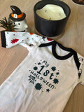 White cotton newborn babygrow with black trim and “My 1st Halloween” spiderweb and stars design on the front