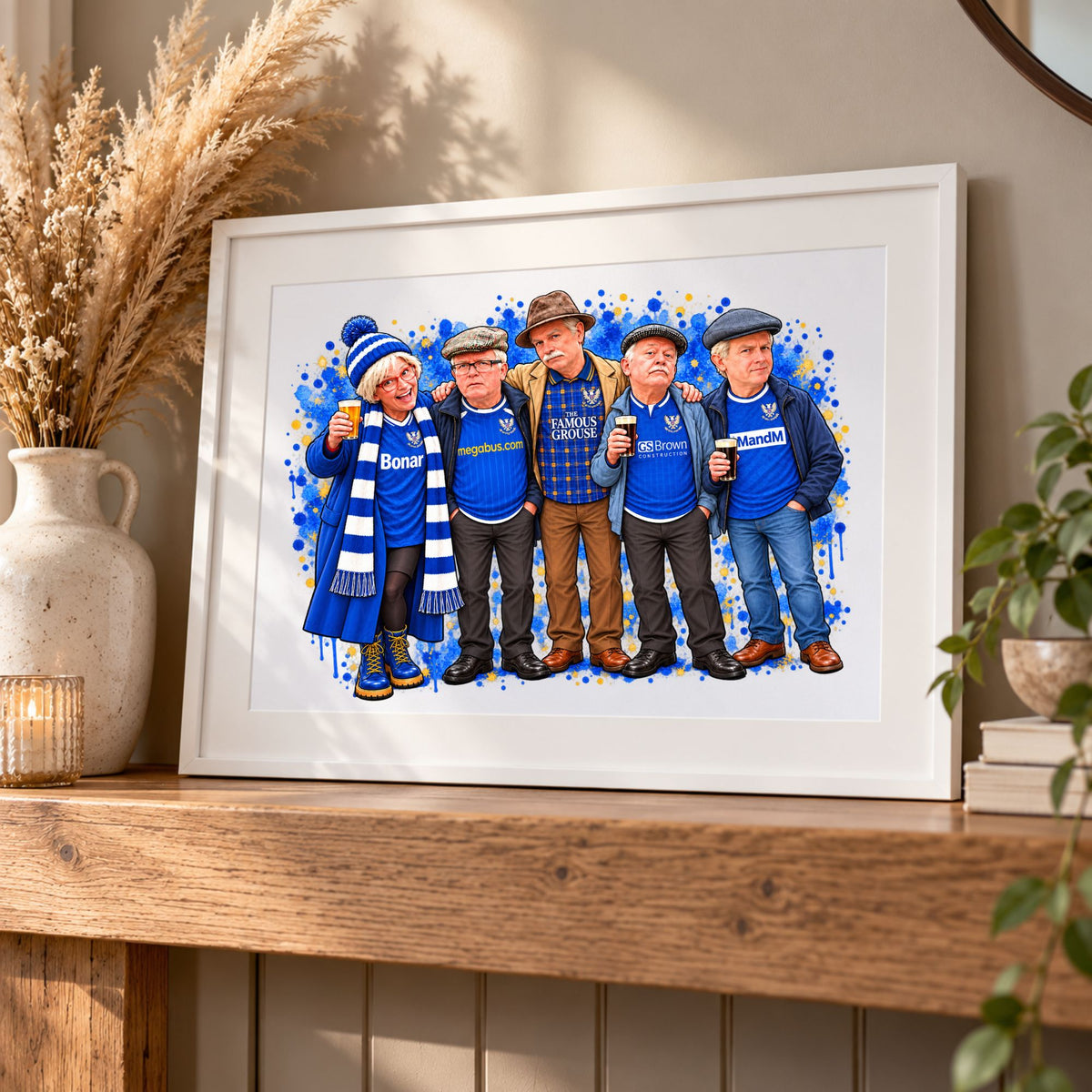 A framed custom watercolor illustration of five men dressed in blue football supporter gear, displayed on a wooden mantelpiece in a cozy home setting.