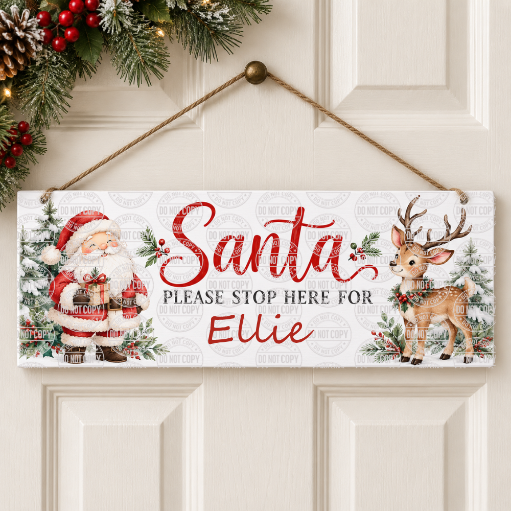 A personalized Christmas wooden sign hanging on a white paneled door. The sign features a white background with a faint repeating watermark pattern, printed with illustrations of Santa Claus on the left, a deer on the right, and the text 'Santa PLEASE STOP HERE FOR Ellie' in red and black.