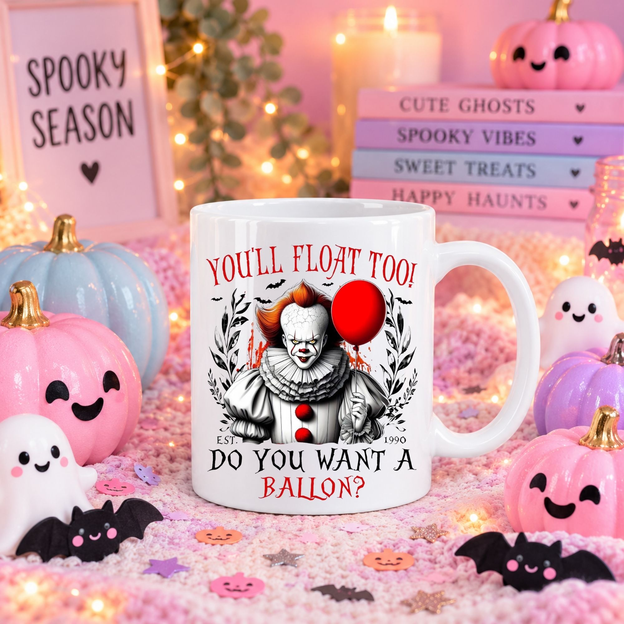 A white ceramic mug with a Pennywise clown graphic and the text 'YOU'LL FLOAT TOO! DO YOU WANT A BALLON?' is shown in a festive Halloween-themed setting with pumpkins, candles, and decorative signs.