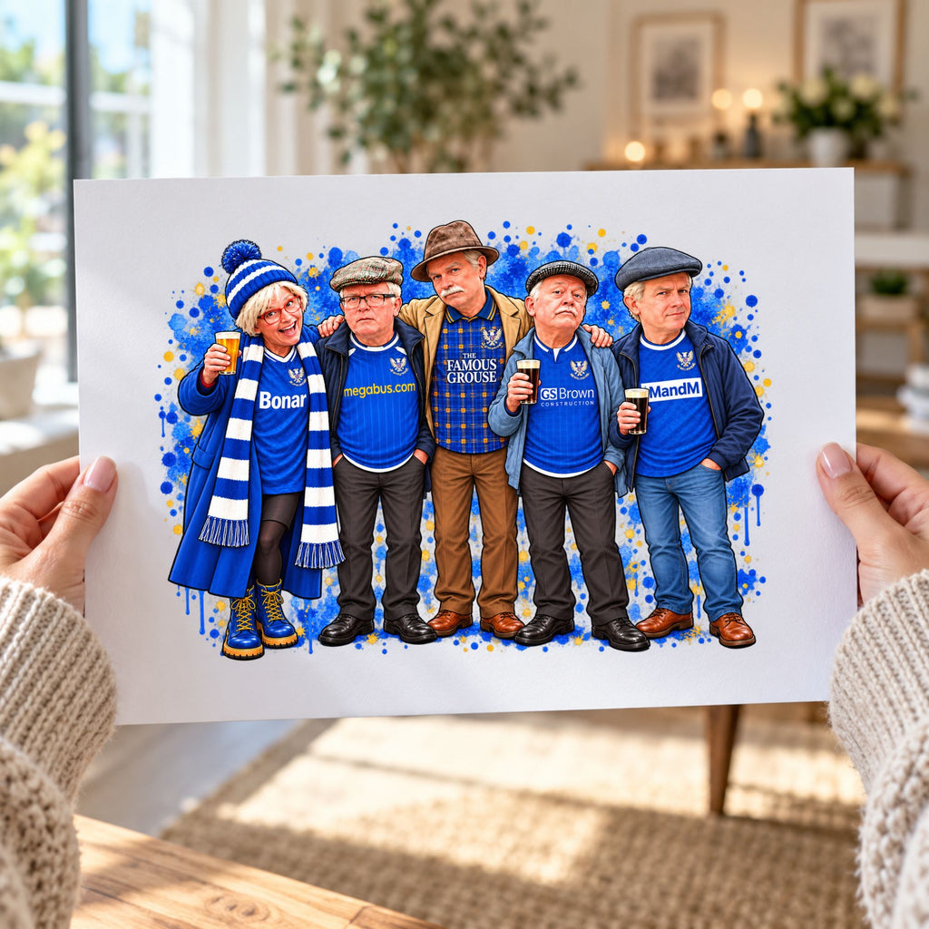 A person holds up a printed illustration/poster showing five stylized men in blue sports jerseys and scarves, with a blue paint-splatter background. The photo is taken indoors with a blurred living-room setting behind it.