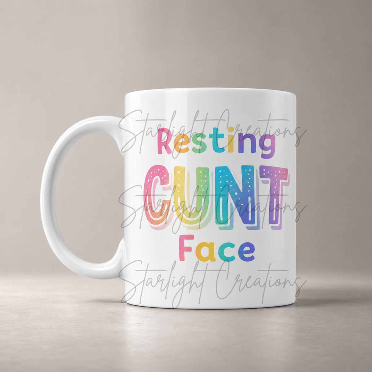 White mug with colorful text on a beige background