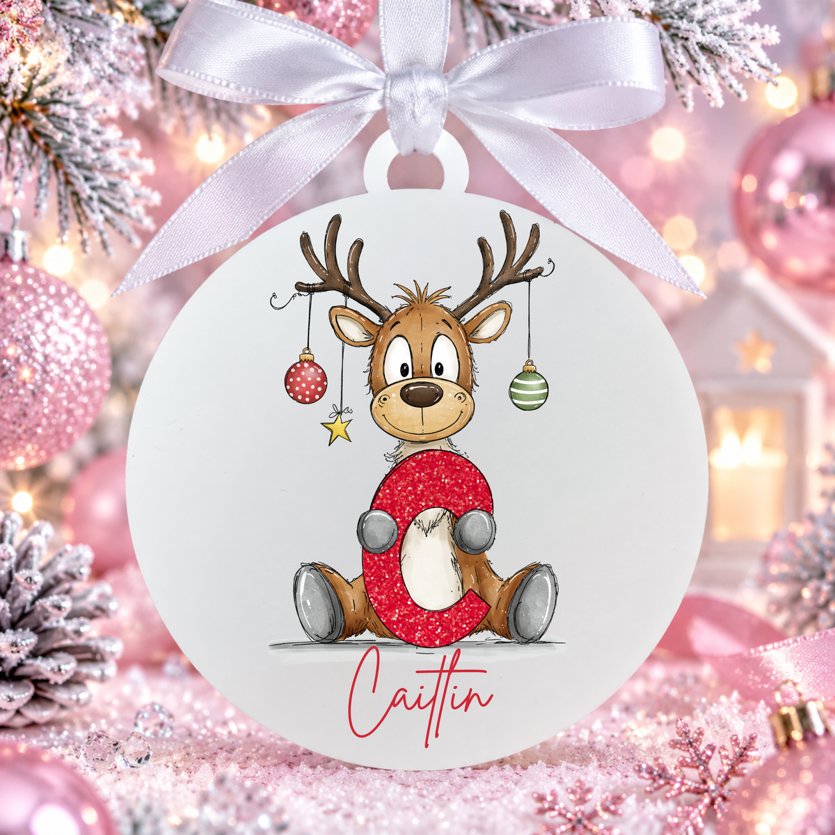Personalised reindeer alphabet Christmas bauble with the name Caitlin, white ribbon, matte white frost acrylic