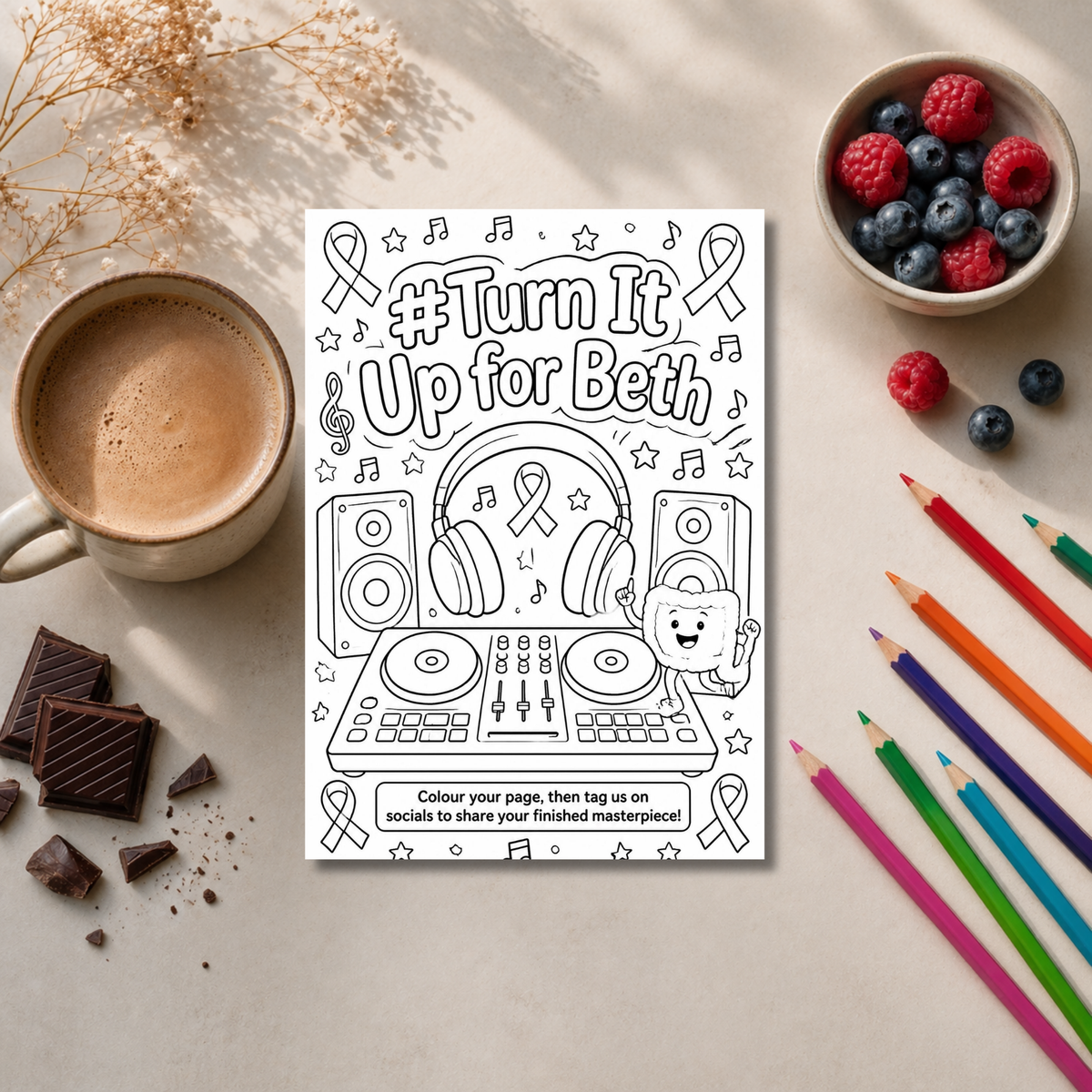 A black-and-white printable coloring page with the text '#Turn It Up for Beth' and a DJ setup illustration, styled on a beige surface with a coffee cup, berries, chocolate, colored pencils, and dried flowers around it.