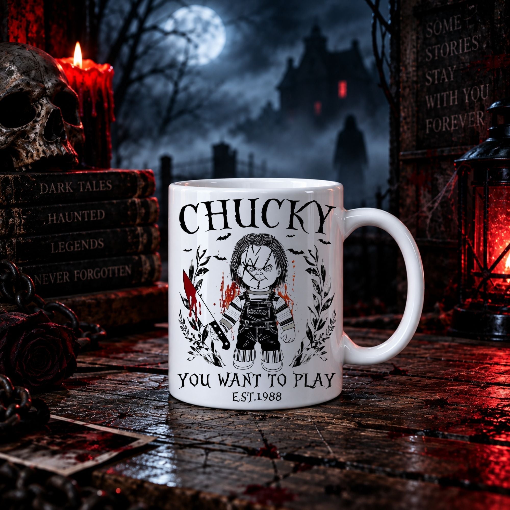 A white ceramic mug with a black and red graphic of Chucky and the text 'CHUCKY YOU WANT TO PLAY EST.1988', set on a dark wooden table surrounded by gothic props like a skull, candle, lantern, and haunted house backdrop.